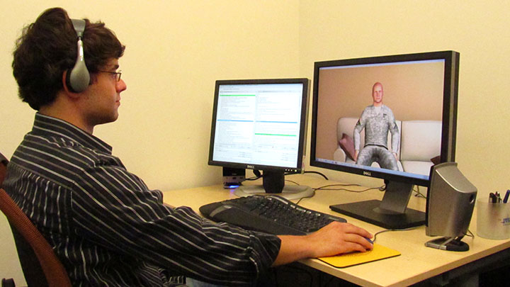 A guy interacting with a virtual army man via his computer